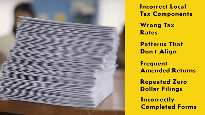 Stack of tax documents highlighting common audit trigger patterns for businesses